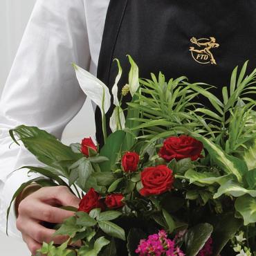 The Florist Designed Blooming and Green Plants in a Basket